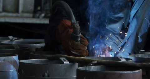 A professional welder makes steel structures at the factory. Stock Footage 166027481