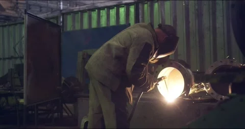 A professional welder makes steel structures at the factory. Stock Footage 166027561