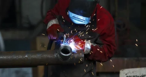 A professional welder makes steel structures at the factory. Stock Footage 166028176