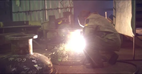 A professional welder makes steel structures at the factory. Stock Footage 166028259