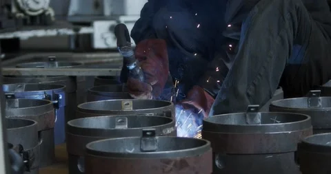 A professional welder makes steel structures at the factory. Stock Footage 166028321