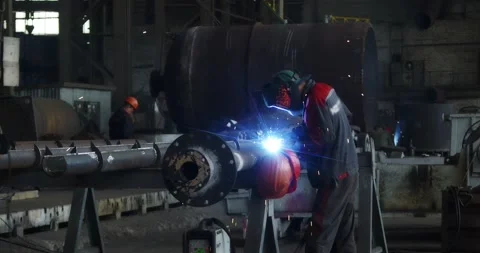 A professional welder makes steel structures at the factory. Stock Footage 166146658