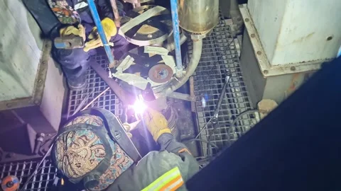 Professional welder performing TIG welding on industrial machinery Stock Footage 347514031