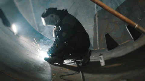 A professional welder works inside a huge tank. Stock Footage 306540342