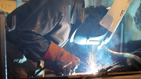 Professional welds metal. The welding process takes place at the factory. Video stock 136661551