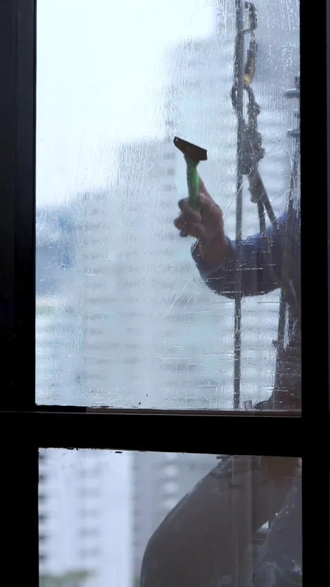 Professional Window Cleaner Using Squeegee on High Rise Skyscraper Exterior Stock-Footage 328266839