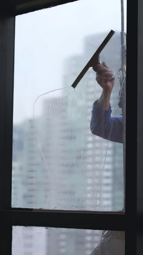 Professional Window Cleaner Using Squeegee on High Rise Skyscraper Video stock 331407330