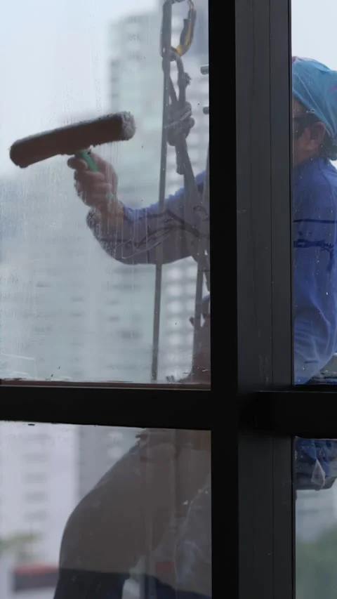 Professional Window Cleaner Using Squeegee on High Rise Skyscraper Video stock 331407331