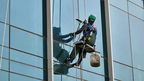Professional Window Cleaner Using Squeegee on Glass Building Видео 340241748