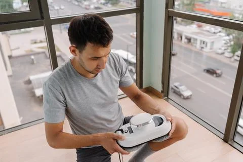 Professional window technician testing advanced robotic system for automated Stock Photos