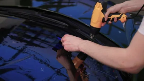 The Professional Windshield Tinting Process Conducted in a Modern Auto Showroom Stock Footage 309965104
