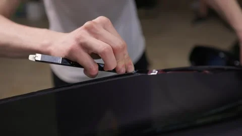 The Professional Windshield Tinting Process Conducted in a Modern Auto Showroom Stock Footage 309965134
