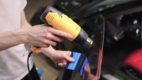 The Professional Windshield Tinting Process Conducted in a Modern Auto Showroom Stock Footage 309965201