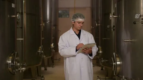 Professional winemaker controlling wine making process and quality at winer.. Stock Footage 286715112