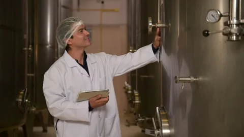 Professional winemaker controlling wine making process and quality at winer.. Stock Footage 286715461