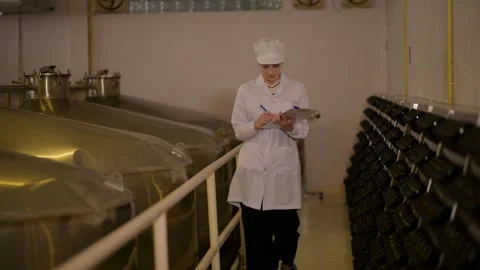 Professional winemaker controlling wine making process and quality at winer.. Stock Footage 286716005