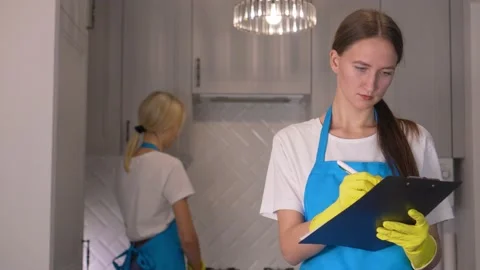 Professional wipers in aprons with help of tablet record data. Stock Footage 231330760