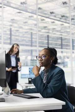 Professional woman analyzing microchips layout on computer in RD office Stock Photos