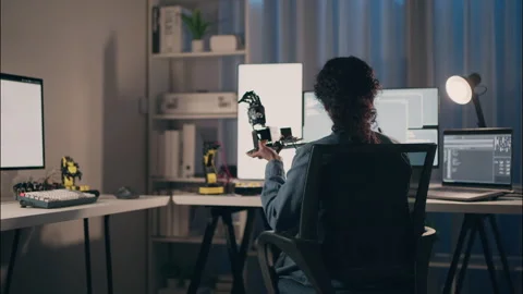 Professional woman engineer testing robotic arm prototype while coding late.. Stock Footage 319001107