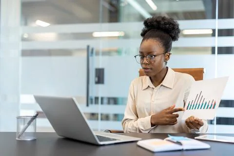 Professional woman presenting data analysis in modern office environment Stock Photos