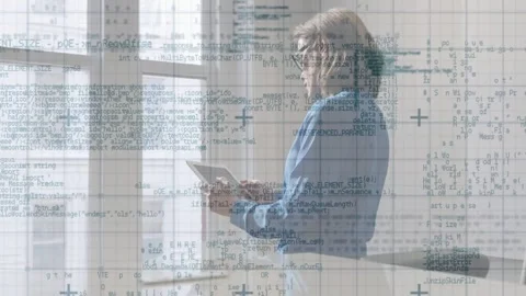 Professional woman tapping tablet by windows, reviewing technology data and Stock Footage 332937063