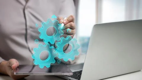 Professional woman using a digital tablet and laptop with virtual glowing g.. Stock Photos