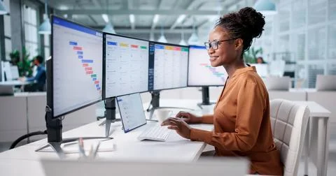 Professional Woman Using Software For Project Agenda On Computer Screen. Stock Photos