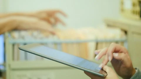 Professional woman using tablet computer to manage digital records in moder.. Stock Footage 334605511