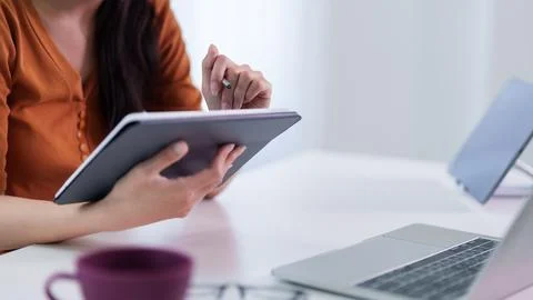 Professional women using digital tablet touchscreen device working at moder.. Stock Photos
