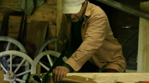 Professional woodworker cutting a rough log with two man crosscut saw Vídeos de archivo 87659683