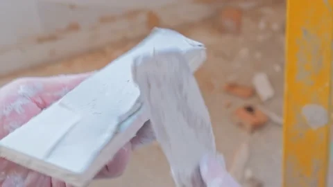 Professional worker applying skim coating material Stockbeeldmateriaal 142951773
