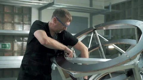 Professional worker assembles a metal structure in a private factory Stock Footage 179699852