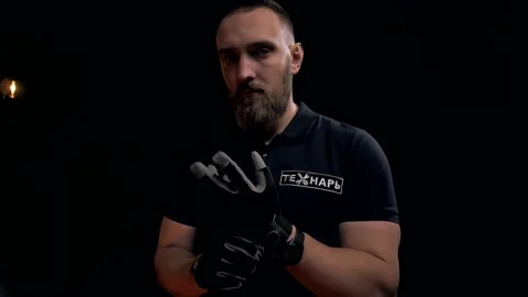 Professional worker with a beard puts on gloves before work. Video stock 151646313