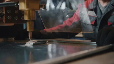 A professional worker behind protective glass works with a metalworking machine Stock-Footage 137485526