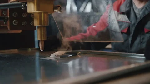 A professional worker behind protective glass works with a metalworking machine Stock Footage 137558523