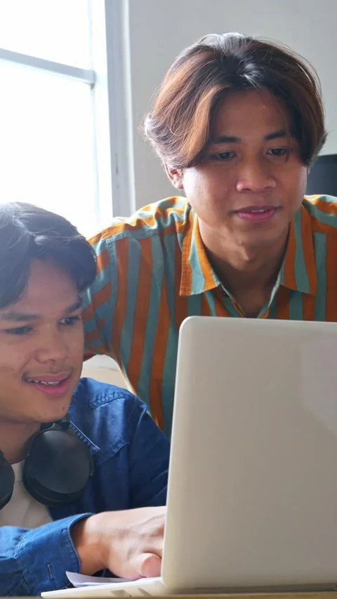 Professional worker collaborating excitedly on laptop project while sharing Stock Footage 319524933
