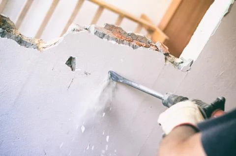 Professional worker in construction site using jackhammer Stock Photos