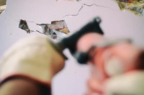 Professional worker in construction site using jackhammer Stock Photos