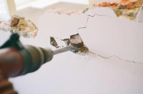 Professional worker in construction site using jackhammer Stock Photos