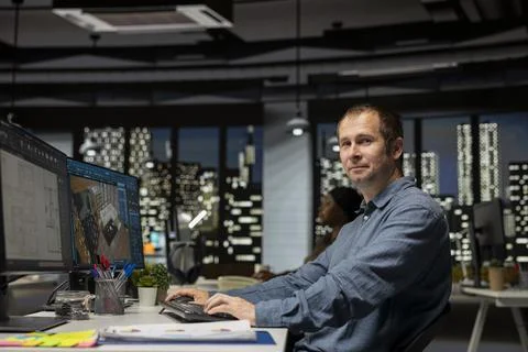 Professional worker in creative office uses CAD software and blueprints plan Stock Photos