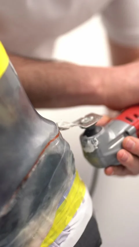 Professional worker cutting prosthetic limb mold in workshop. Vertical video Stock Footage 237607470