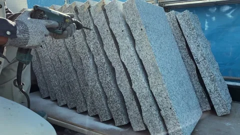 A professional worker drills granite to prepare it for installation on the bu Stock Footage 166148508