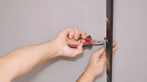 Professional worker fasten ceiling profiles in new flat Stock Footage 144624843