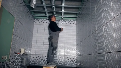 Professional worker fix ceiling profiles. Man loving his job Stock Footage 127063116