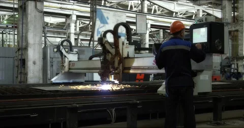 A professional worker in a helmet stands with a laser cutting machine. Stock Footage 166148770