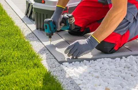 Professional Worker Installing Poolside Composite Material Deck Stock Photos