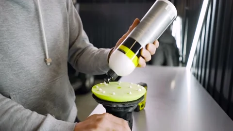 Professional worker man applying a polishing paste or car wax for polish car Stock Footage 150680619