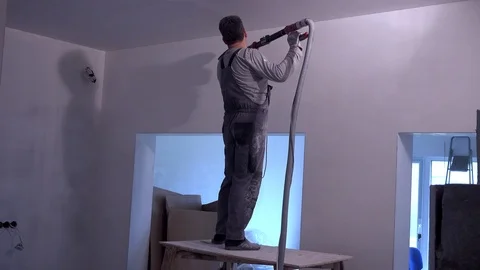 Professional worker polishing ceiling with grinding sandpaper machine Stock Footage 106958600