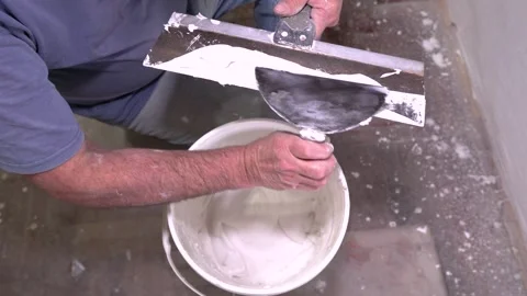 Professional Worker Preparing Drywall Mud with Taping Knife Stock Footage 323869757