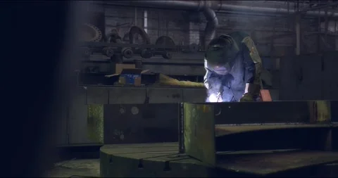 A professional worker in a protective mask works with a grinder in a factory Stock Footage 166026634